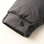 Long puffer jacket cuff with elastic hem and dark button detail