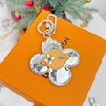Louis Vuitton floral charm keyring with silver monogram and tan center