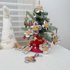 Flower-shaped keychains with silver monogram petals and tan leather centers on a Christmas tree