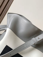 Loewe bag strap and top seam detail with light gray leather and dark inset panel