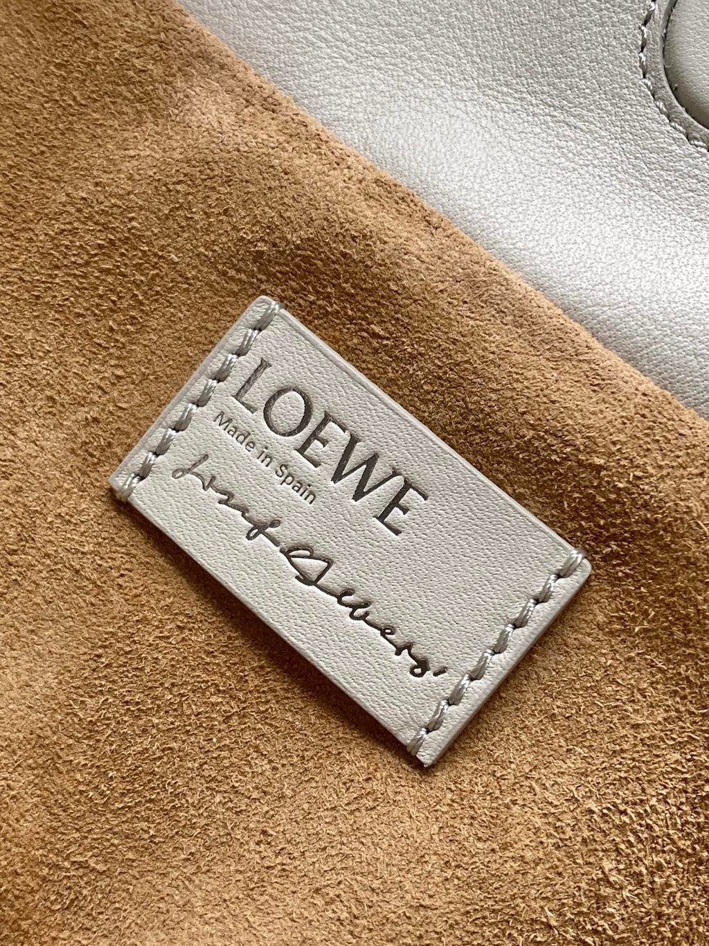 Loewe tag on tan suede lining with "Made in Spain" text