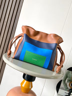Loewe bag with tan leather top, navy and blue panels, and green front insert