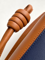 Loewe bag close-up of braided tan cord handle and leather shoulder strap
