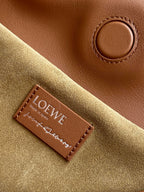 Loewe bag suede label patch with LOEWE branding on tan and olive fabric