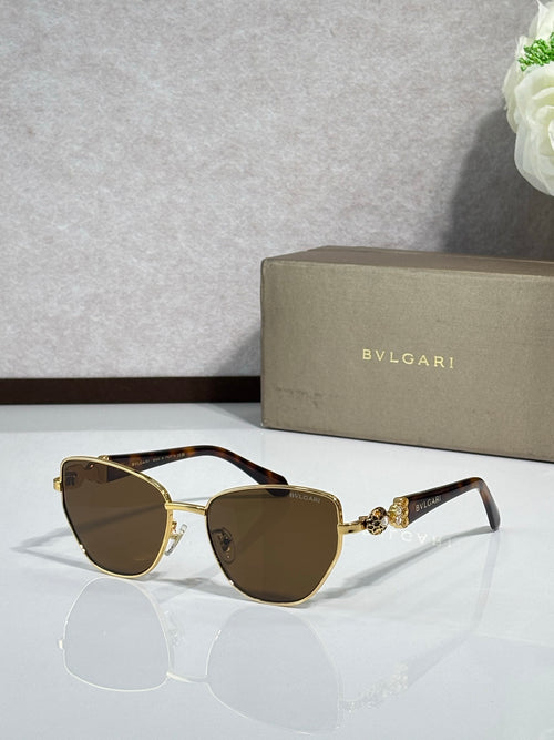 Brown cat-eye sunglasses with gold metal accents and amber gradient lenses.