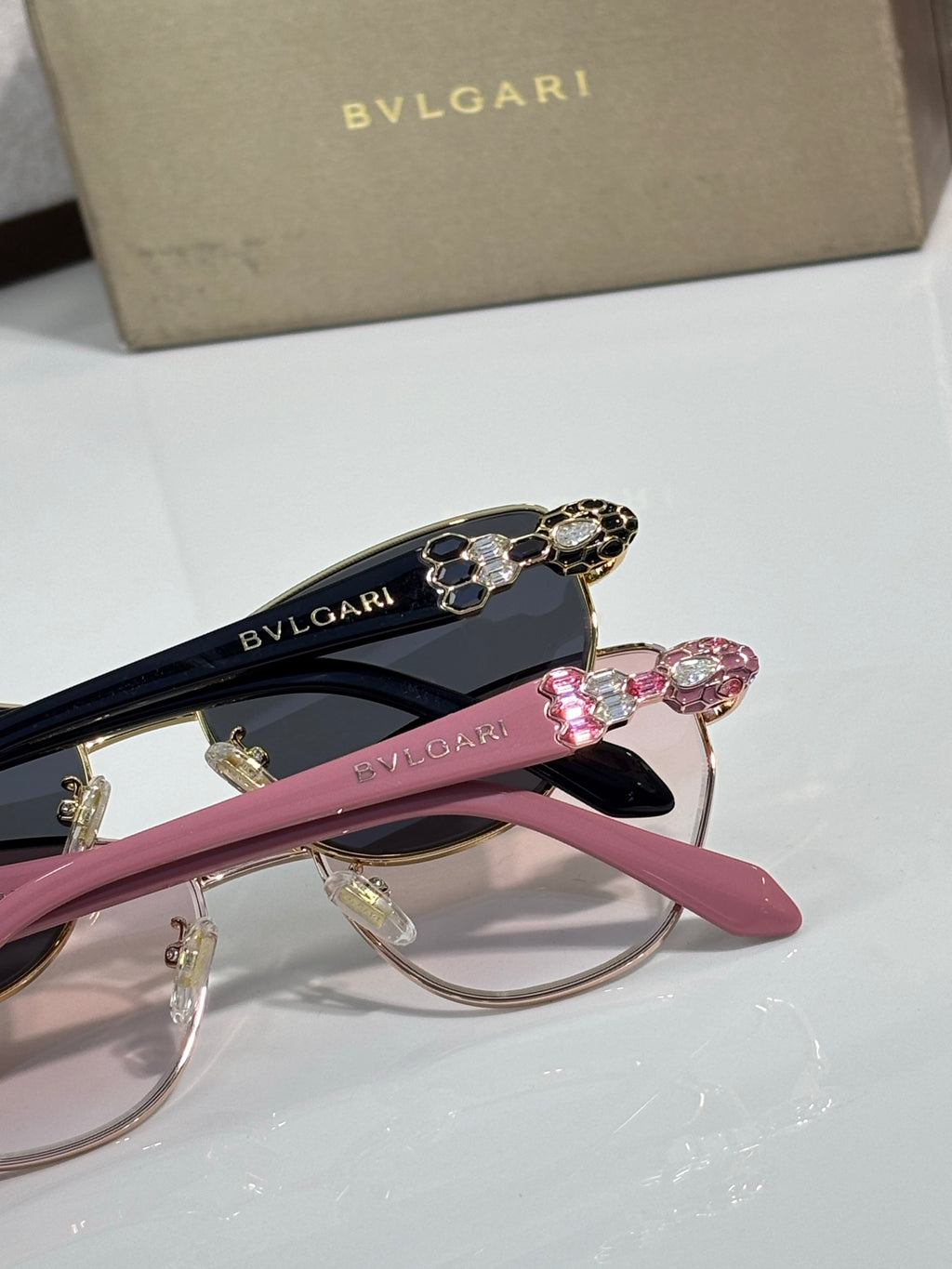Jeweled cat-eye sunglasses in pink and dark tones with BVLGARI logo on temples.