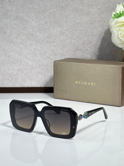 Bvlgari sunglasses with black frames and dark lenses, side view of embellished temples.