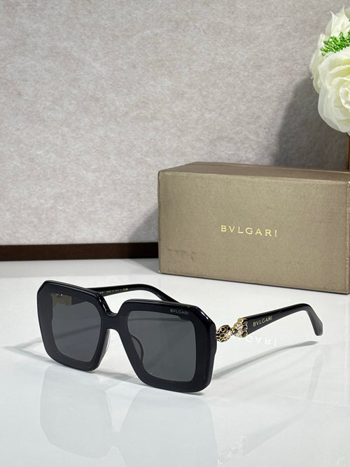 Bvlgari sunglasses with black frames and dark lenses, jeweled temple detail.