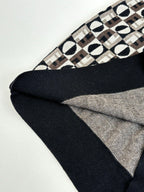 Knit sweater hem with black ribbed edging and Fendi monogram patterned body