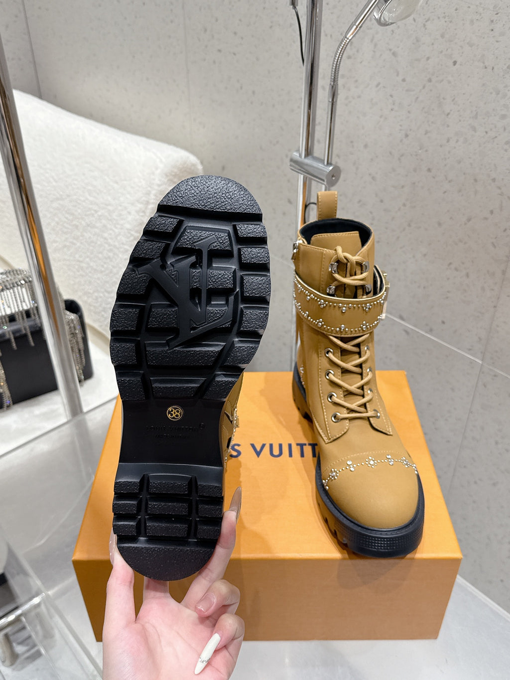 Tan ankle boot outsole view with lace-up front and chunky tread sole