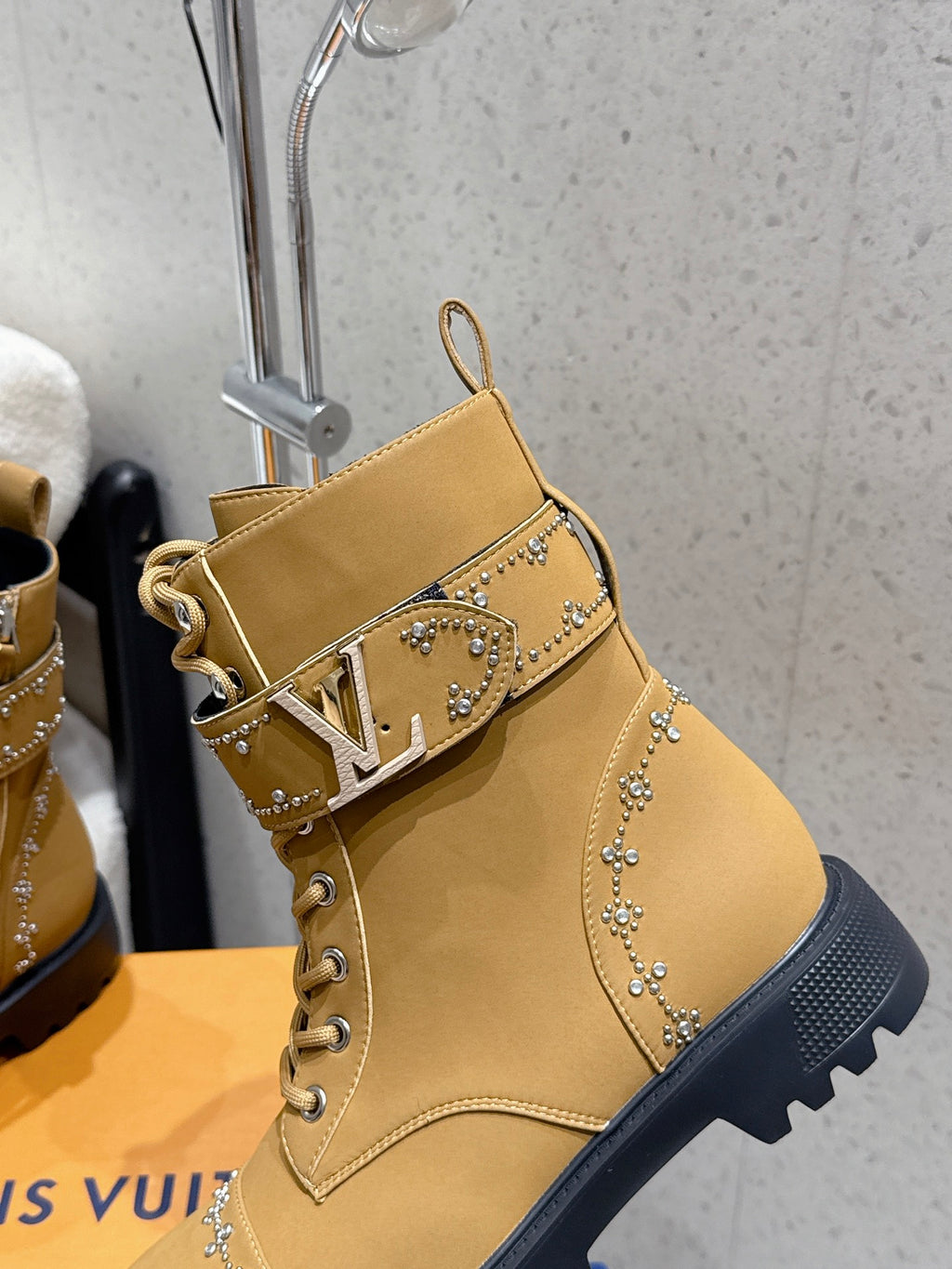 Tan ankle boot with LV monogram strap and rhinestone-studded trim