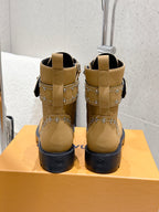 Back view of tan lace-up ankle boots with studded trim and black soles