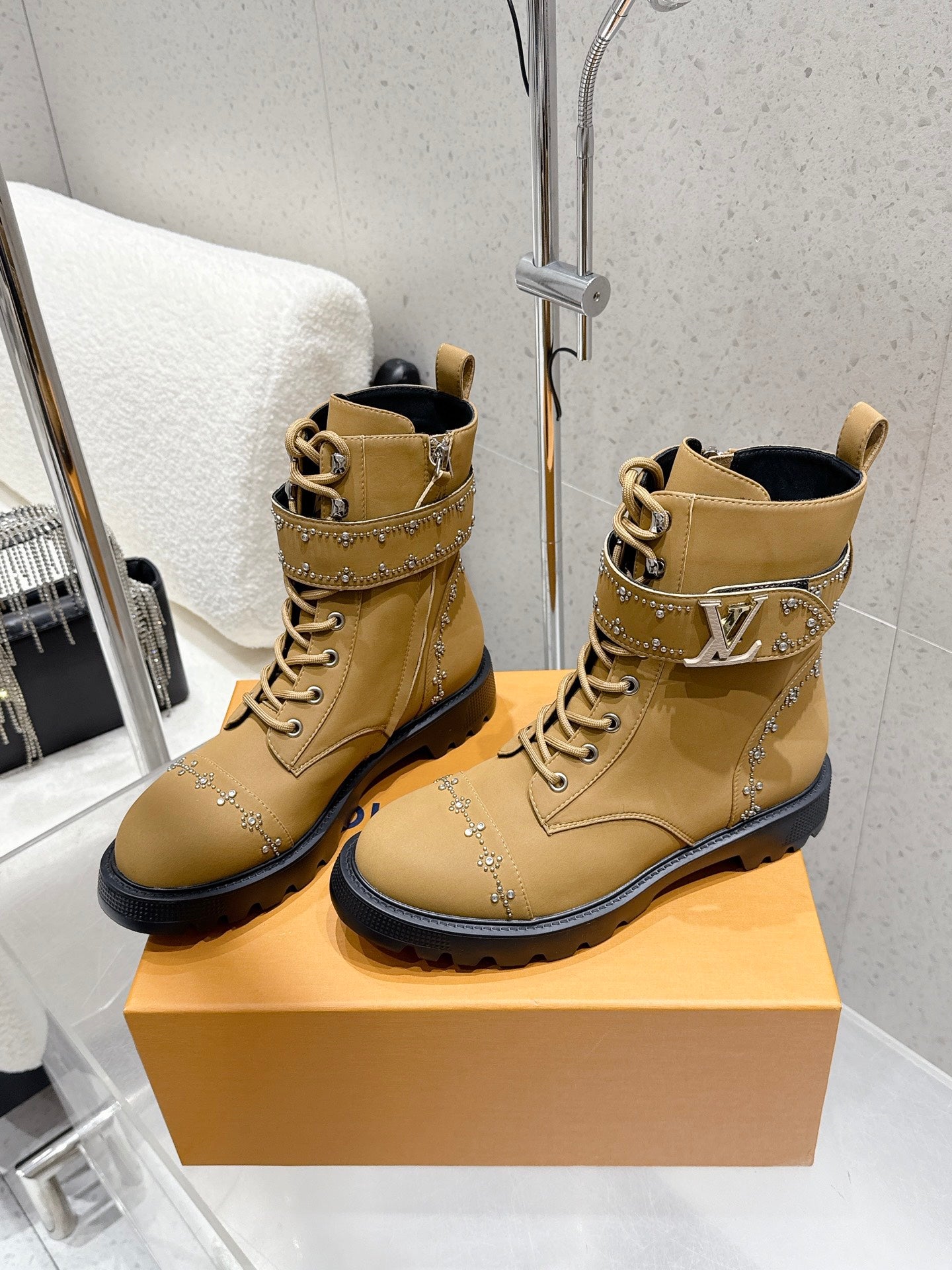 Tan lace-up ankle boots with studded panel detailing and black rubber sole