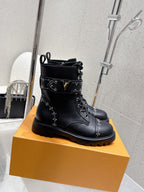 Black lace-up ankle boots with studded trim and side logo detail