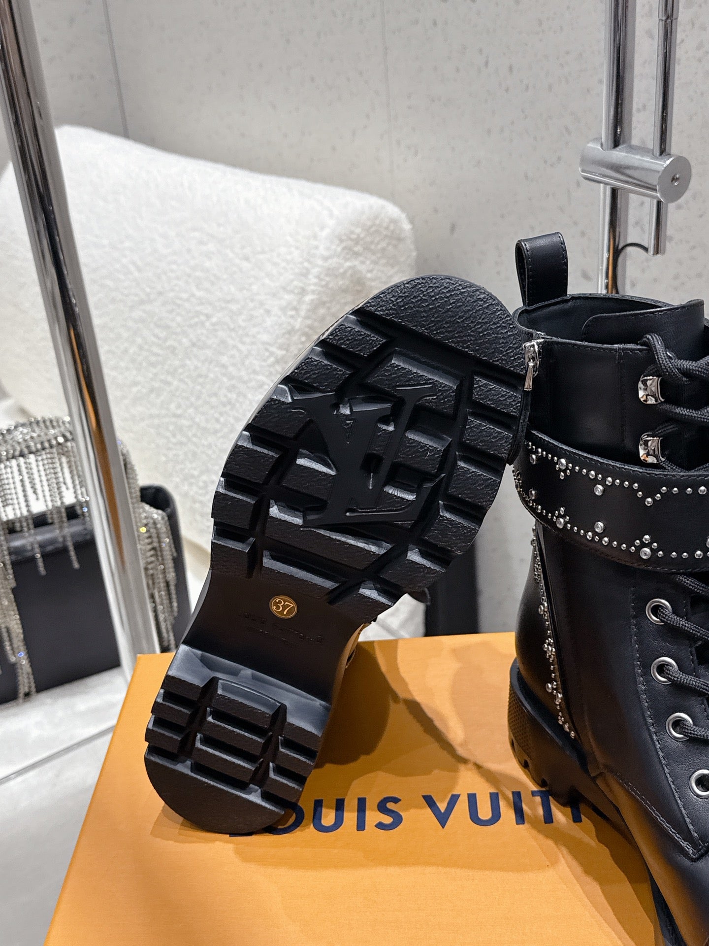 Black boot outsole and side view; studded boot with lug tread