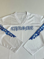 White V-neck jersey front close-up with blue logo across the chest and sleeves