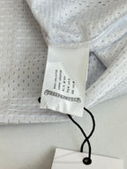 White long-sleeve jersey neck label and black string tie detail