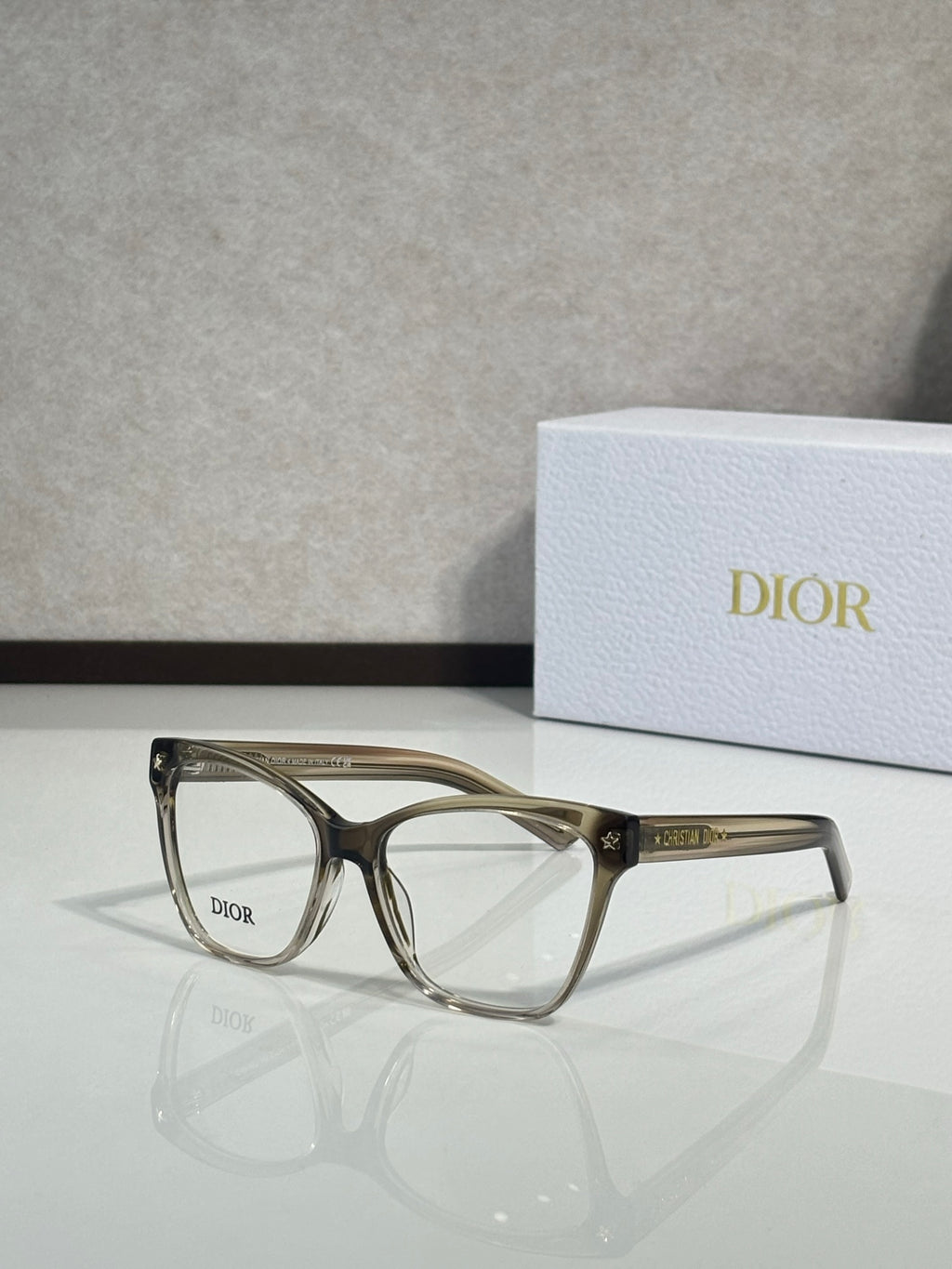 Black eyeglass frames with clear lenses and logo on temple