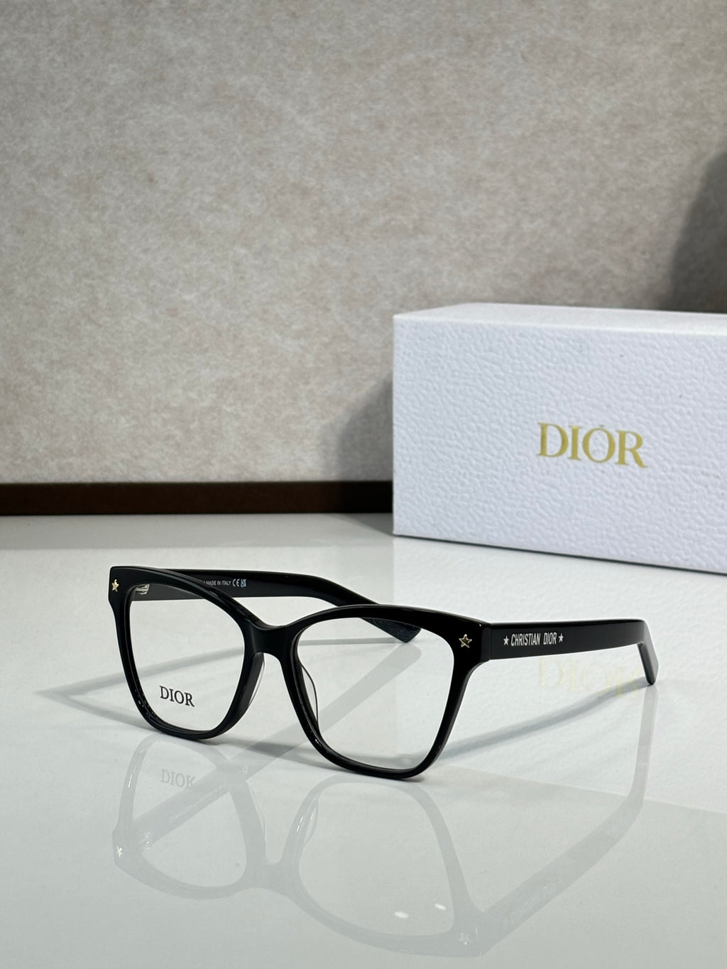 Matte black eyeglass frames with clear lenses and star detailing