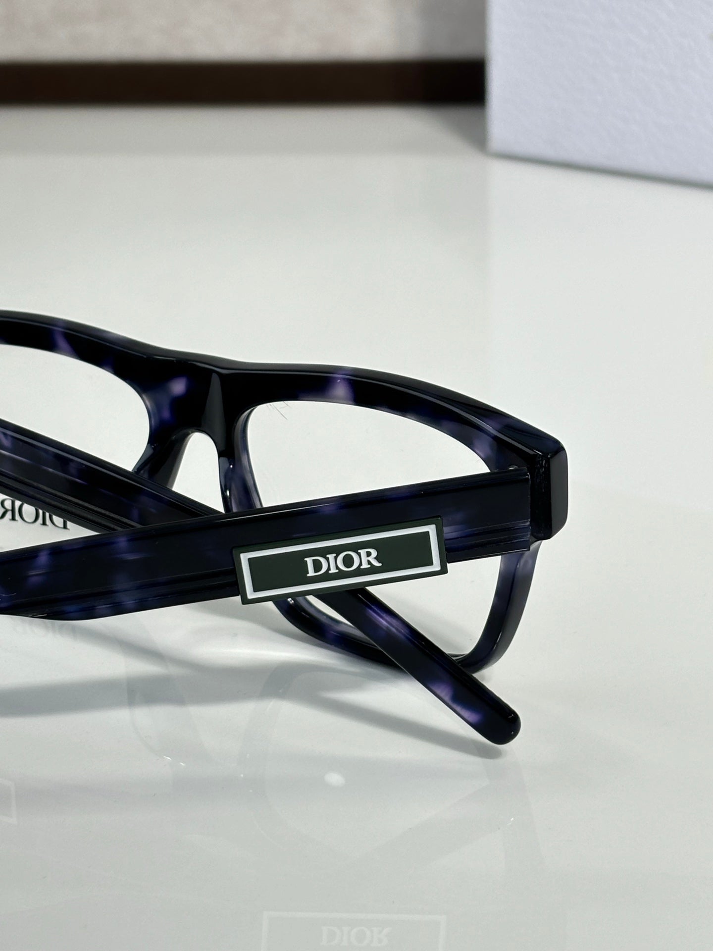 Dior rectangular eyeglasses with dark frames and logo temple, close-up side view