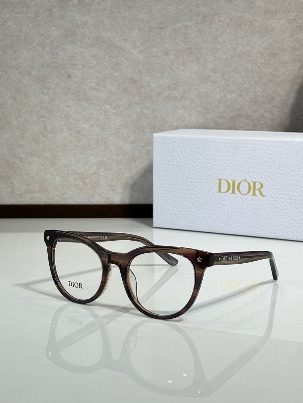 Brown tortoiseshell full-rim eyeglasses with round frames and clear lenses, Dior logo