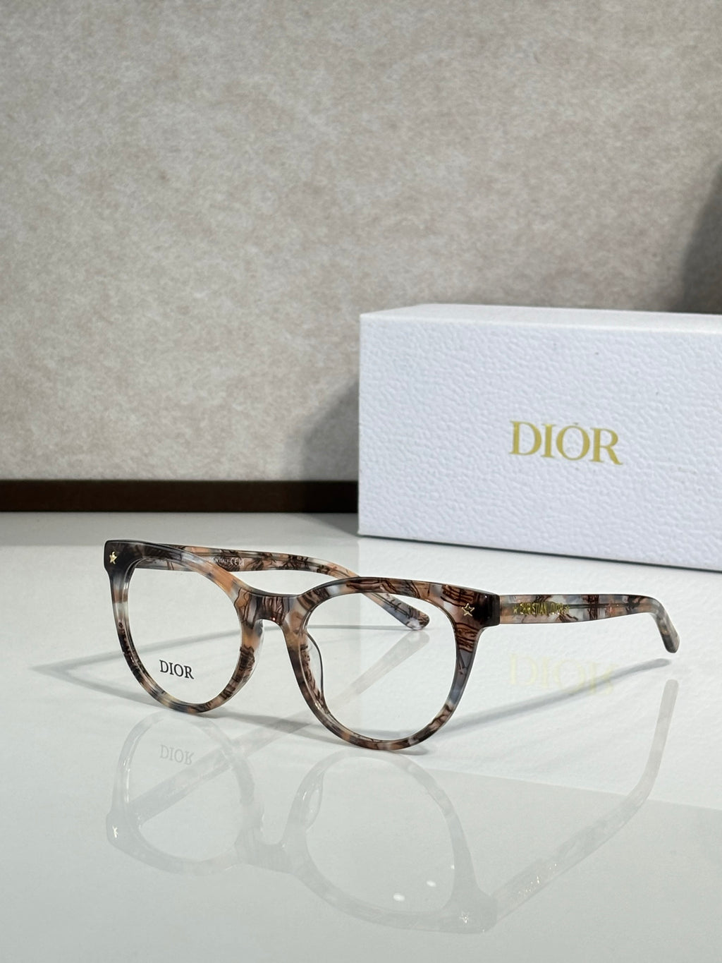 Multicolor tortoiseshell full-rim eyeglasses with round frames and clear lenses, Dior logo