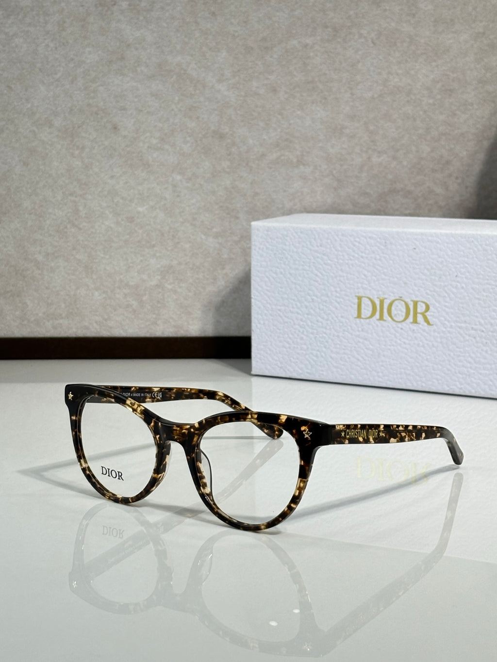 Dark tortoiseshell full-rim eyeglasses with round frames and clear lenses, Dior logo