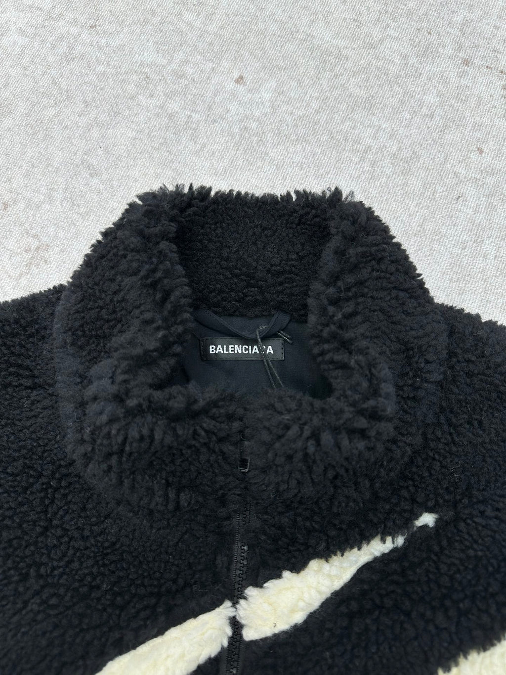 Black fleece jacket with Balenciaga neck logo and off-white stripe detail