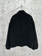 Black shearling-style jacket back view with full-length zip and raised collar
