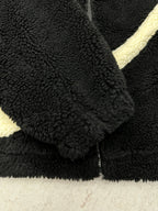Black fleece jacket cuff and button detail with off-white trim