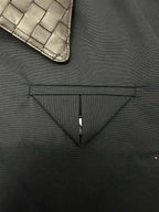Dark jacket chest detail with triangular seam and zipper placket