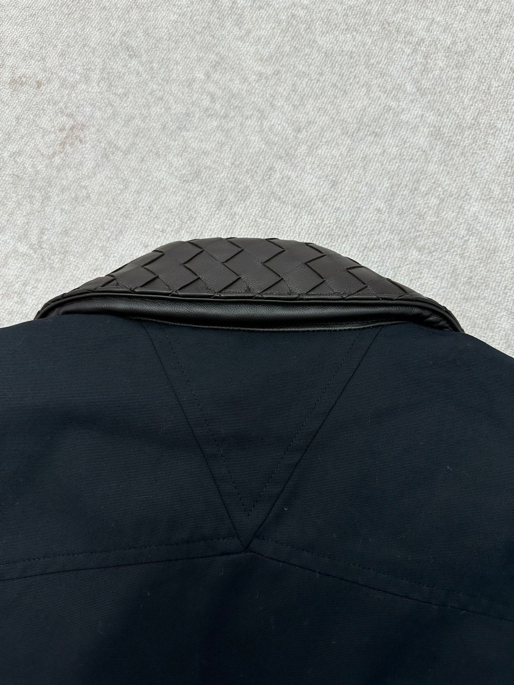 Dark jacket back yoke with quilted collar panel detail