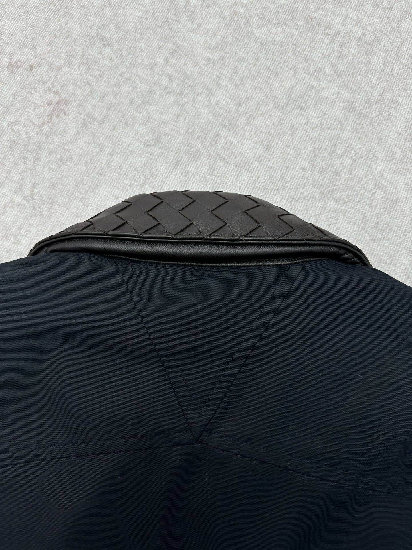 Dark jacket back yoke with quilted collar panel detail