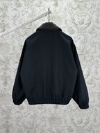 Dark jacket back view with ribbed hem and stand collar