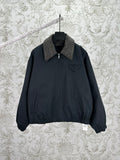 Dark zip-up jacket with stand collar and chest logo pocket