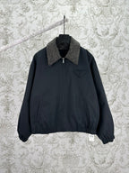 Dark zip-up jacket with stand collar and chest logo pocket