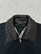 Dark jacket collar with quilted leather-look panel and front zipper