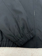 Dark jacket sleeve and hem with elastic cuff and gathered finish
