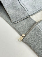 Amiri hoodie close-up of silver zipper pull and metal slider on light gray knit