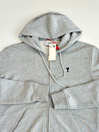 Amiri light gray hoodie close-up: hood, drawstrings, full-zip front