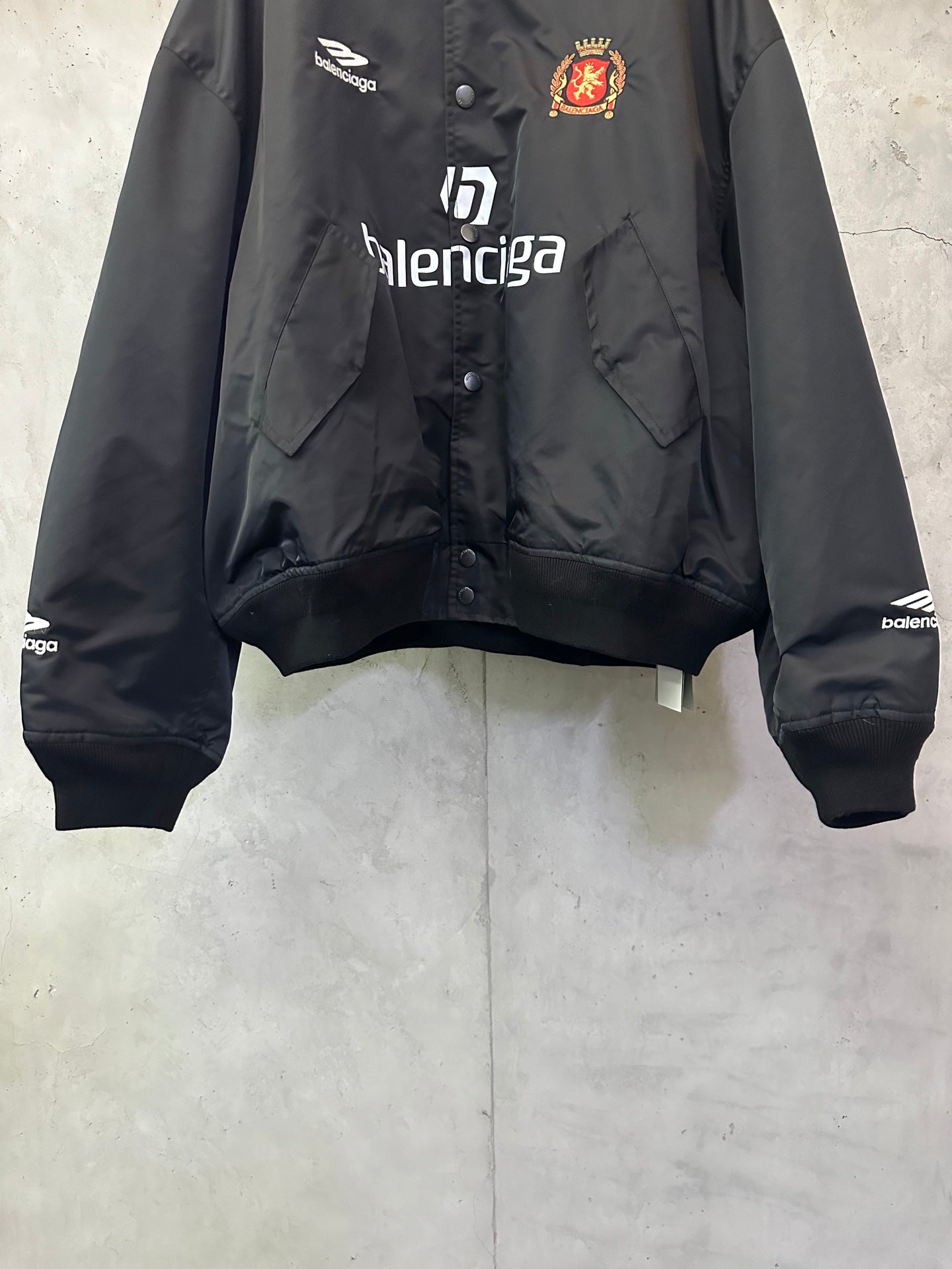 Balenciaga black bomber jacket with crest patch and front Balenciaga logo