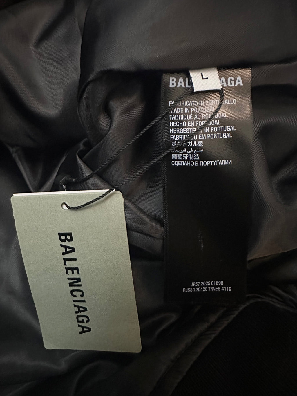 Balenciaga black jacket care label with hanging brand tag