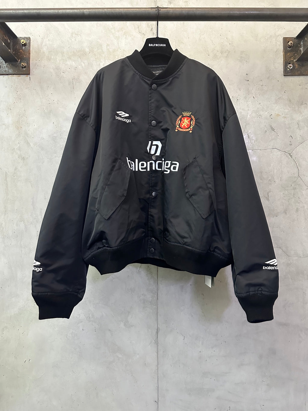 Balenciaga black bomber jacket with button front and crest logo patch