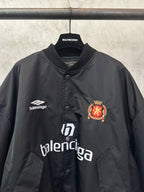 Balenciaga black bomber jacket with crest patch, Balenciaga logo, and button placket