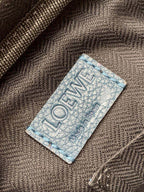 Loewe logo tag on blue fabric strap with woven texture