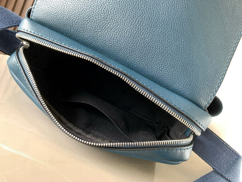 Blue Loewe crossbody bag open with black interior and silver-tone zipper