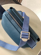 Blue Loewe bag with gold-tone zipper and adjustable strap, side view