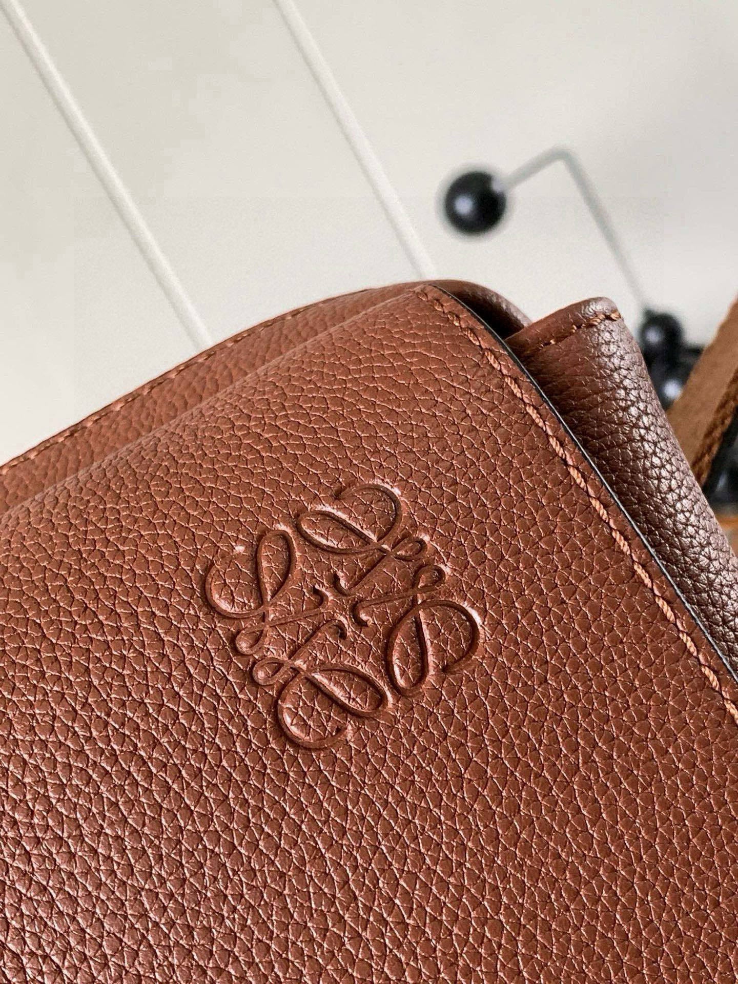 Loewe men's leather bag with embossed logo on front panel