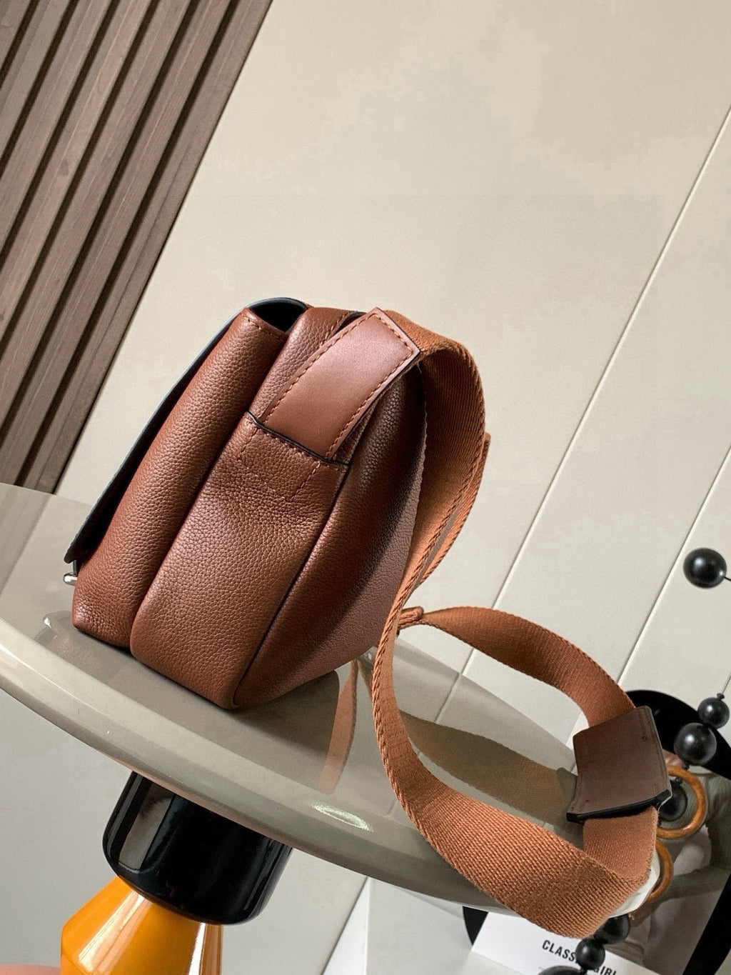 Loewe men's small leather crossbody bag, side view with adjustable shoulder strap