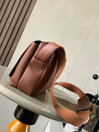 Loewe men's small leather crossbody bag, side view with adjustable shoulder strap